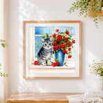 Finished grey kitten with red roses cross stitch artwork displayed