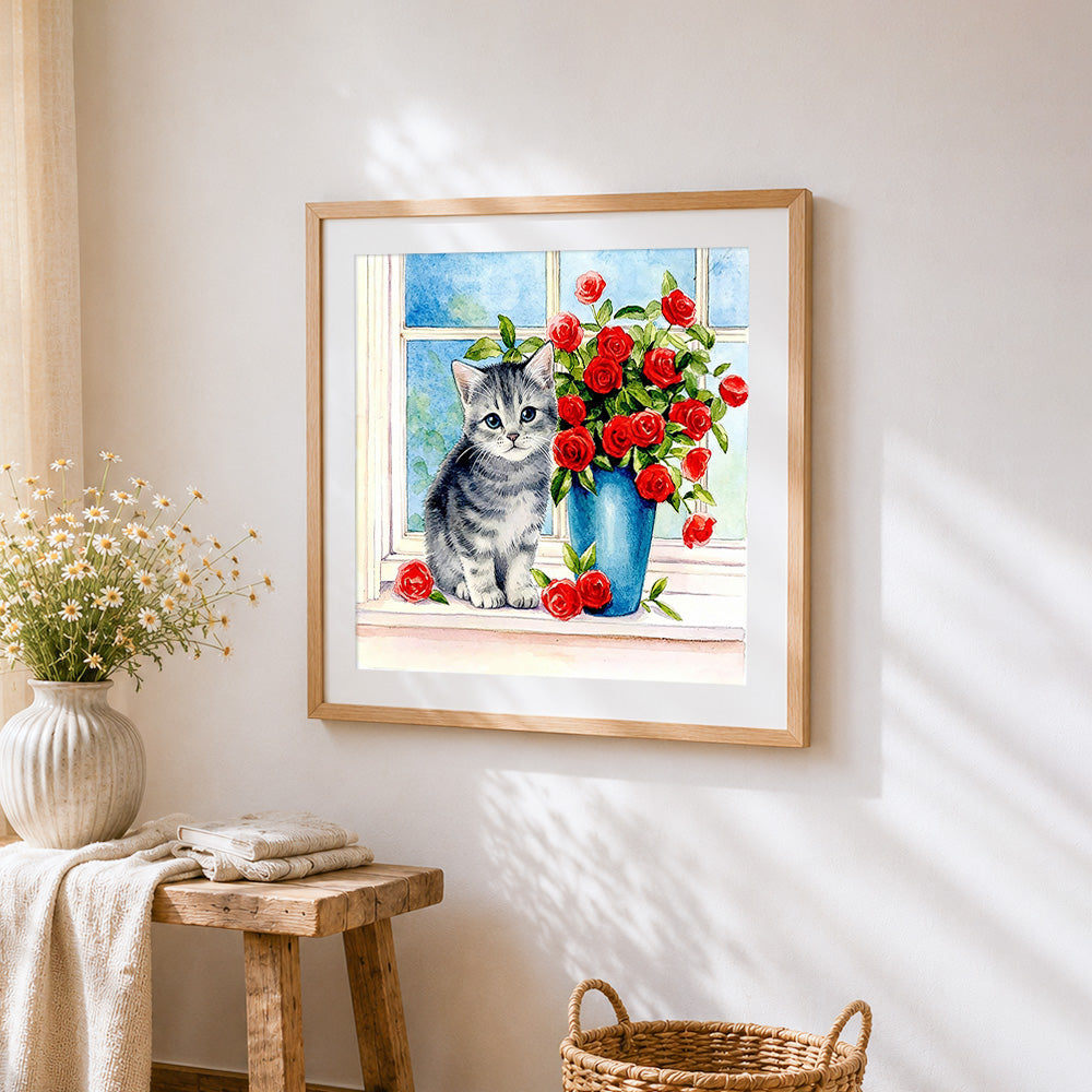 Grey kitten with red roses cross stitch artwork displayed on wall as home decor