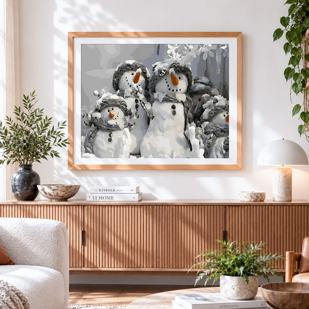 Finished group of snowmen in winter hats cross stitch artwork displayed
