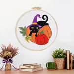 Finished halloween black cat and pumpkins artwork displayed on a wall