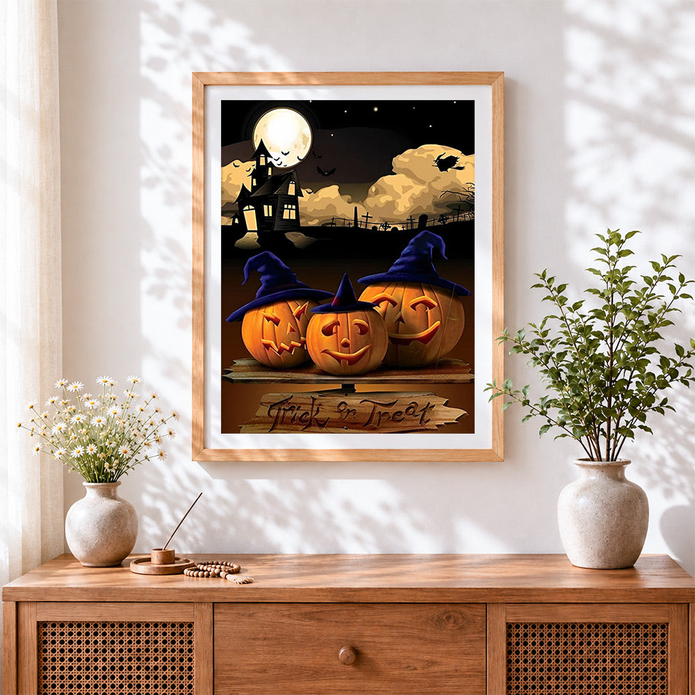 Finished halloween jack-o'-lanterns and haunted house cross stitch artwork displayed