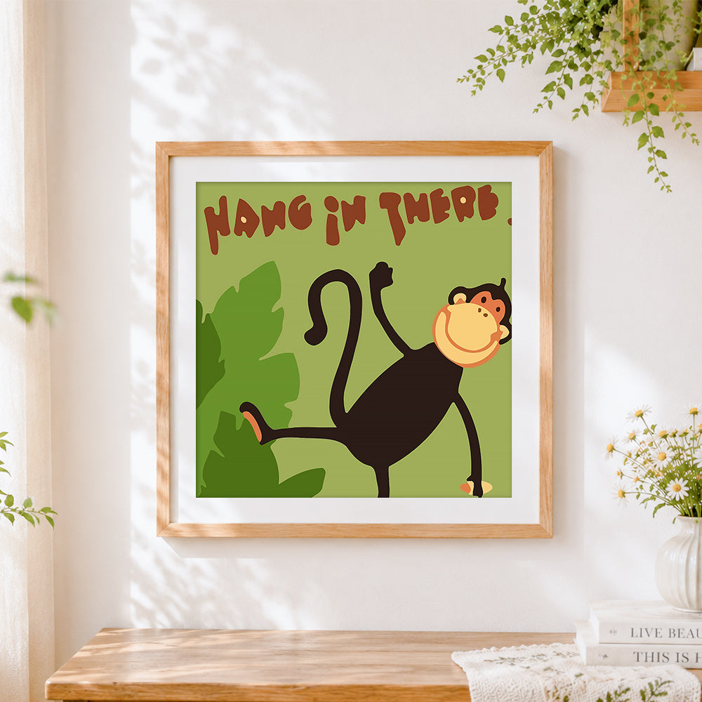 Finished "hang in there" cartoon monkey cross stitch artwork displayed