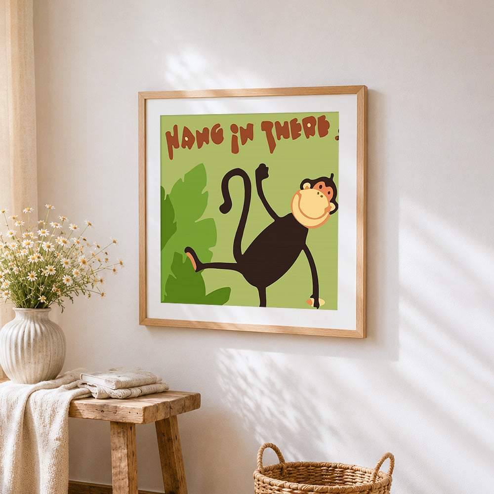 "Hang in there" cartoon monkey cross stitch artwork displayed on wall as home decor