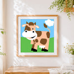 Finished happy cartoon cow cross stitch artwork displayed