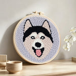 Happy husky punch needle artwork displayed on a table