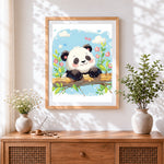 Finished happy panda on a branch cross stitch artwork displayed