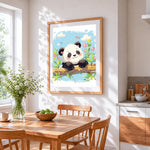 Happy panda on a branch cross stitch artwork displayed on wall as home decor