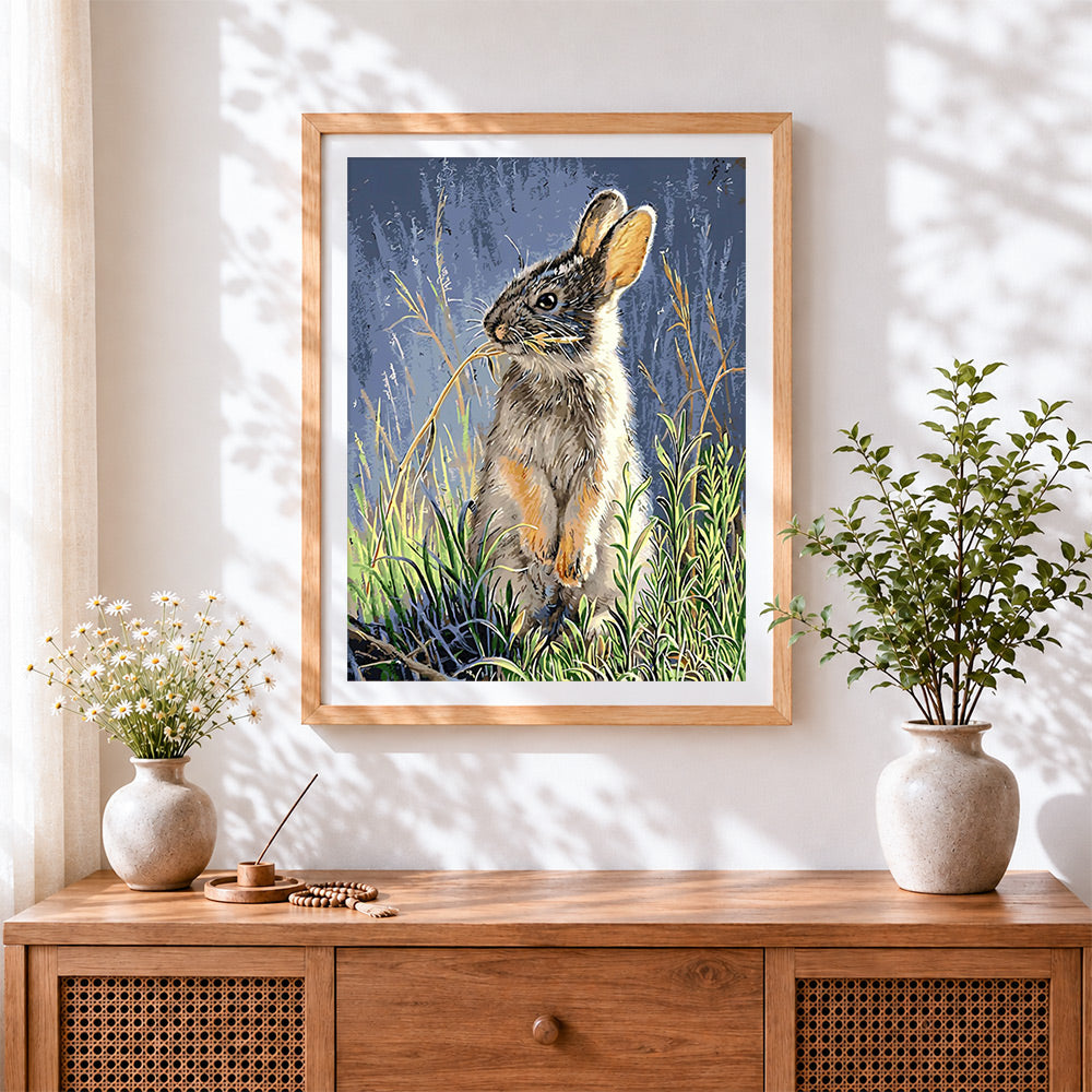Finished hare in grass cross stitch artwork displayed