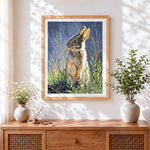 Finished hare in grass cross stitch artwork displayed