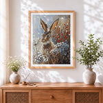 Finished hare in snow cross stitch artwork displayed