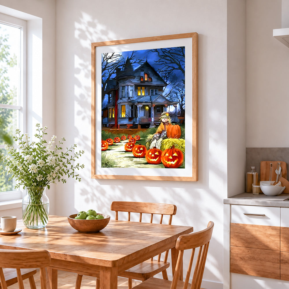 Haunted house and glowing pumpkins cross stitch artwork displayed on wall as home decor