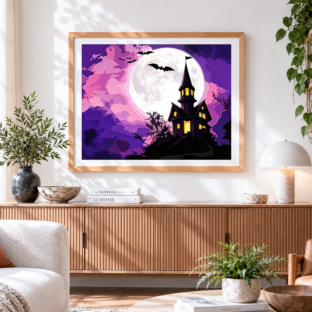 Finished haunted house on a hill with full moon cross stitch artwork displayed