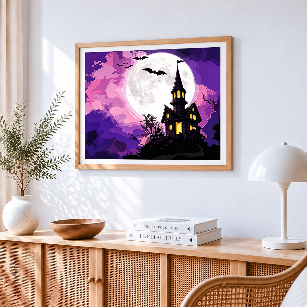 Haunted house on a hill with full moon cross stitch artwork displayed on wall as home decor
