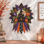 Haunted house quilted bow displayed as handmade wall decor in a cozy home