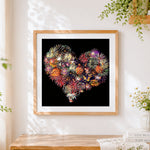 Finished heart shaped fireworks cross stitch artwork displayed