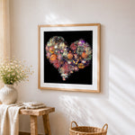 Heart shaped fireworks cross stitch artwork displayed on wall as home decor