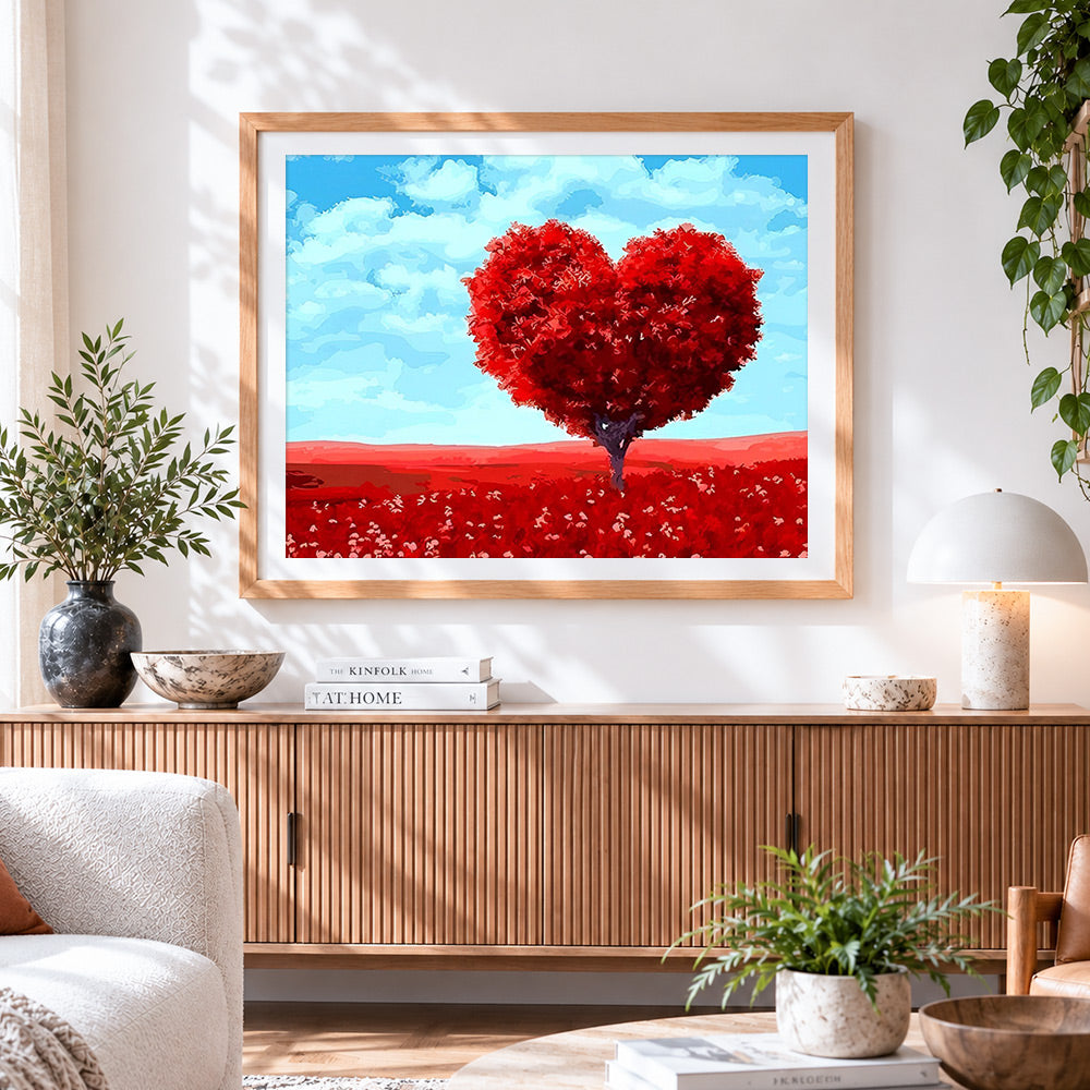 Finished heart-shaped red tree cross stitch artwork displayed