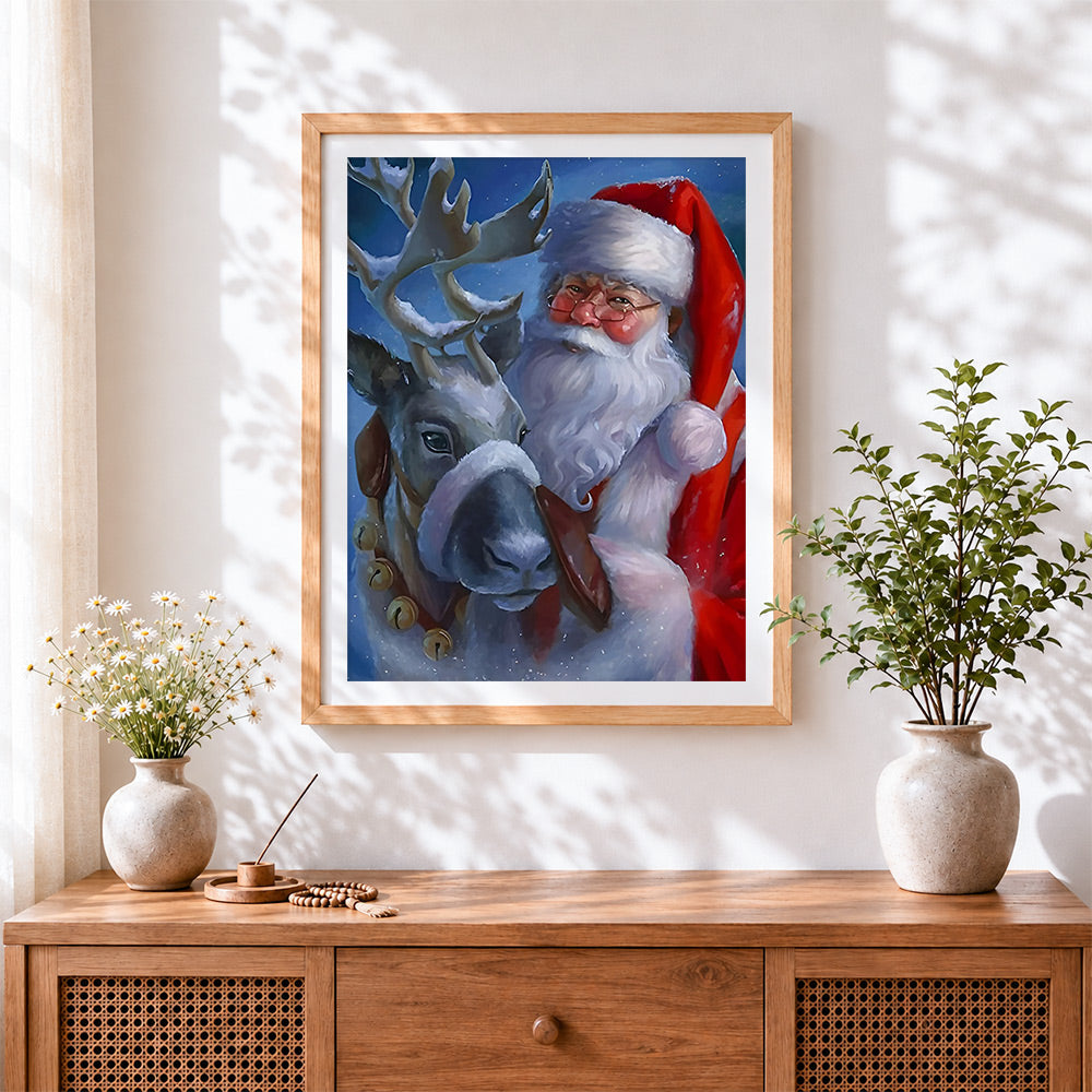 Finished heartwarming father christmas and reindeer cross stitch artwork displayed