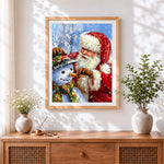 Finished heartwarming father christmas and snowman cross stitch artwork displayed