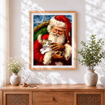 Finished heartwarming santa holding kitten cross stitch artwork displayed