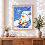 Finished heartwarming snowman and puppy cuddling cross stitch artwork displayed
