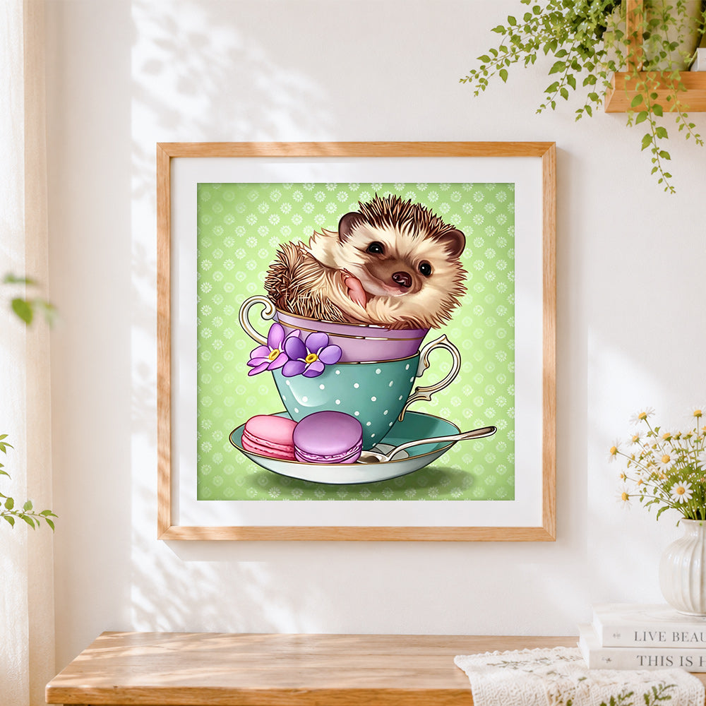 Finished hedgehog in a teacup with macarons cross stitch artwork displayed