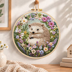 Hedgehog in wild blooms embroidery hoop wall art displayed as warm and cozy handmade home decor