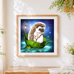 Finished hedgehog sailing in a leaf boat cross stitch artwork displayed