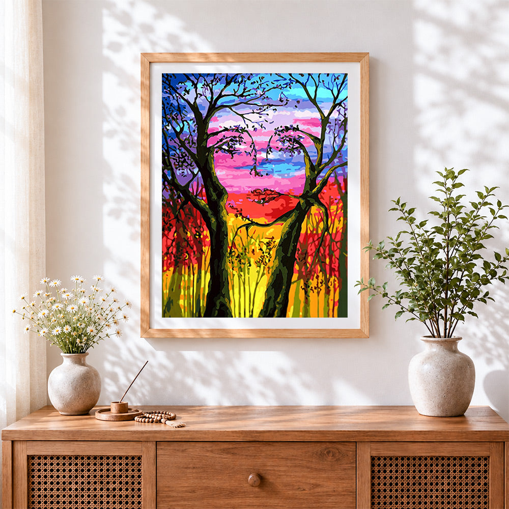 Finished hidden face tree silhouette cross stitch artwork displayed