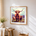 Highland cow family in the mountains cross stitch artwork displayed on wall as home decor