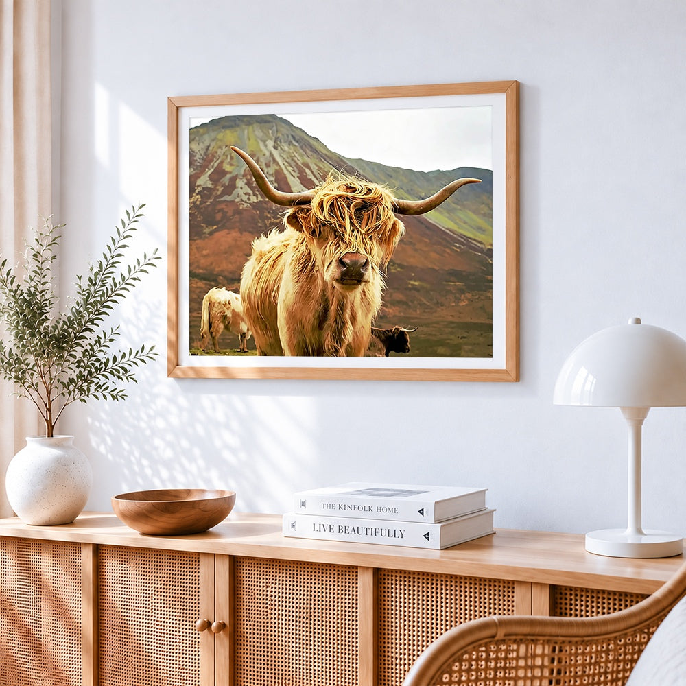 Highland cow in mountains cross stitch artwork displayed on wall as home decor