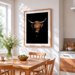 Highland cow on black background cross stitch artwork displayed on wall as home decor