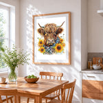 Highland cow with sunflowers and tartan scarf cross stitch artwork displayed on wall as home decor