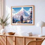 Hiker facing snowy mountain cross stitch artwork displayed on wall as home decor