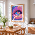 Holographic lips with lollipop cross stitch artwork displayed on wall as home decor