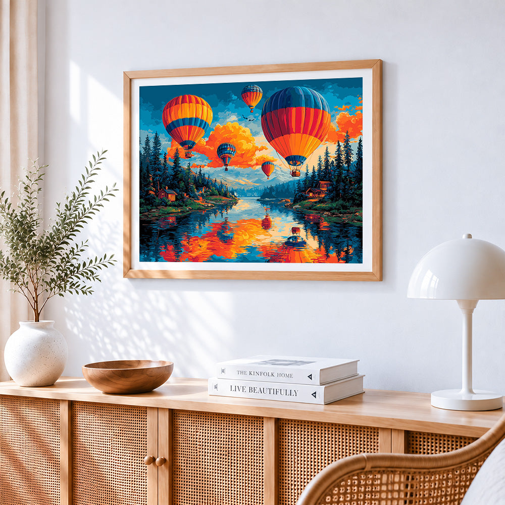 Hot air balloons over lake at sunset cross stitch artwork displayed on wall as home decor