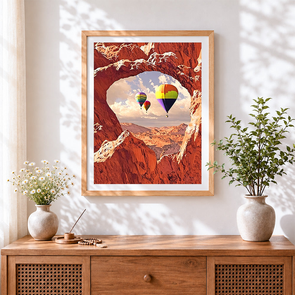 Finished hot air balloons through a heart cave cross stitch artwork displayed