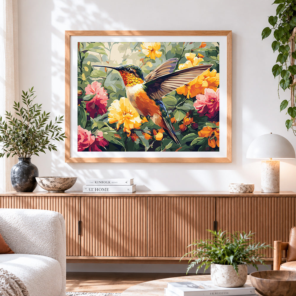 Finished hummingbird among colourful flowers cross stitch artwork displayed