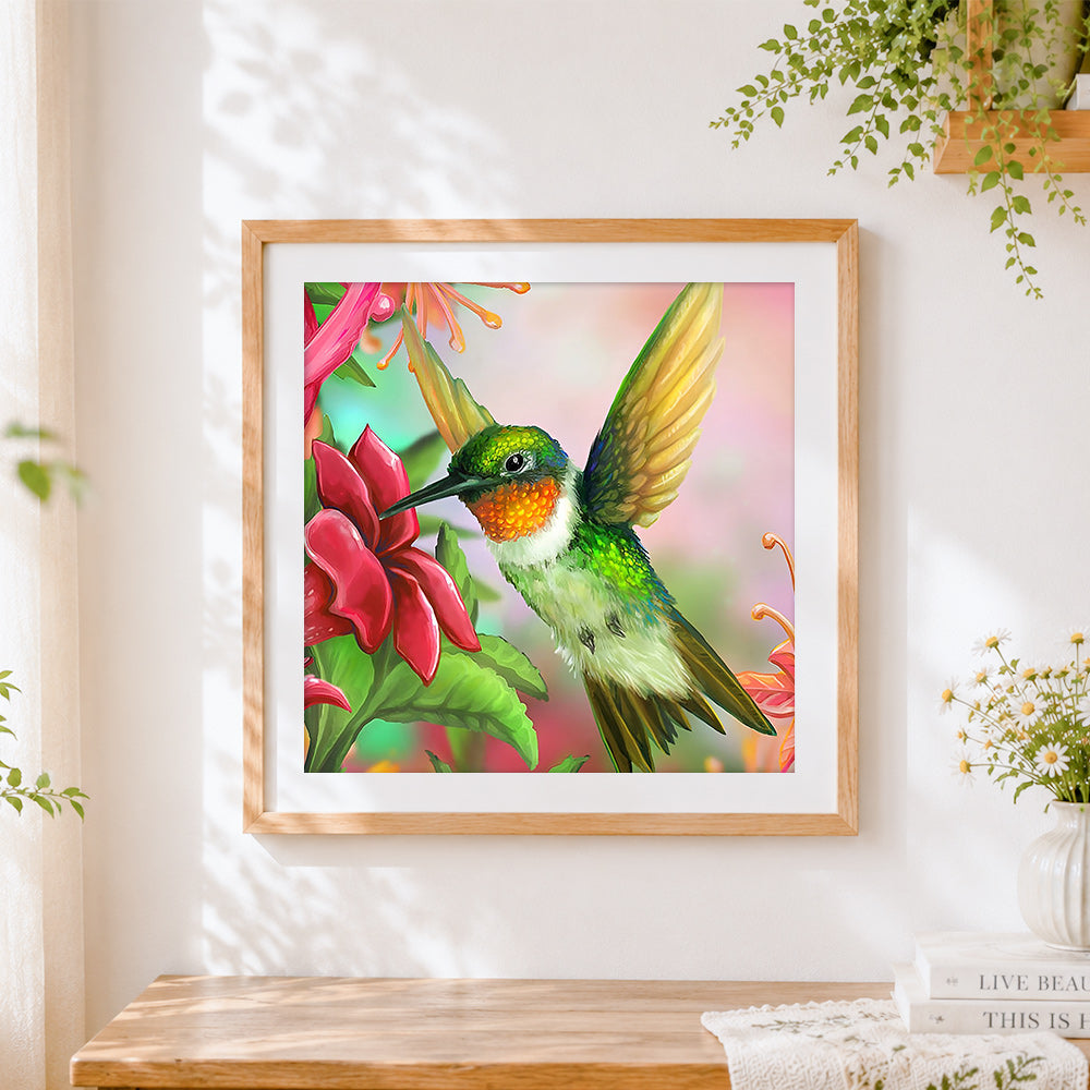 Finished hummingbird and pink flower cross stitch artwork displayed