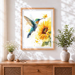 Finished hummingbird and sunflower cross stitch artwork displayed