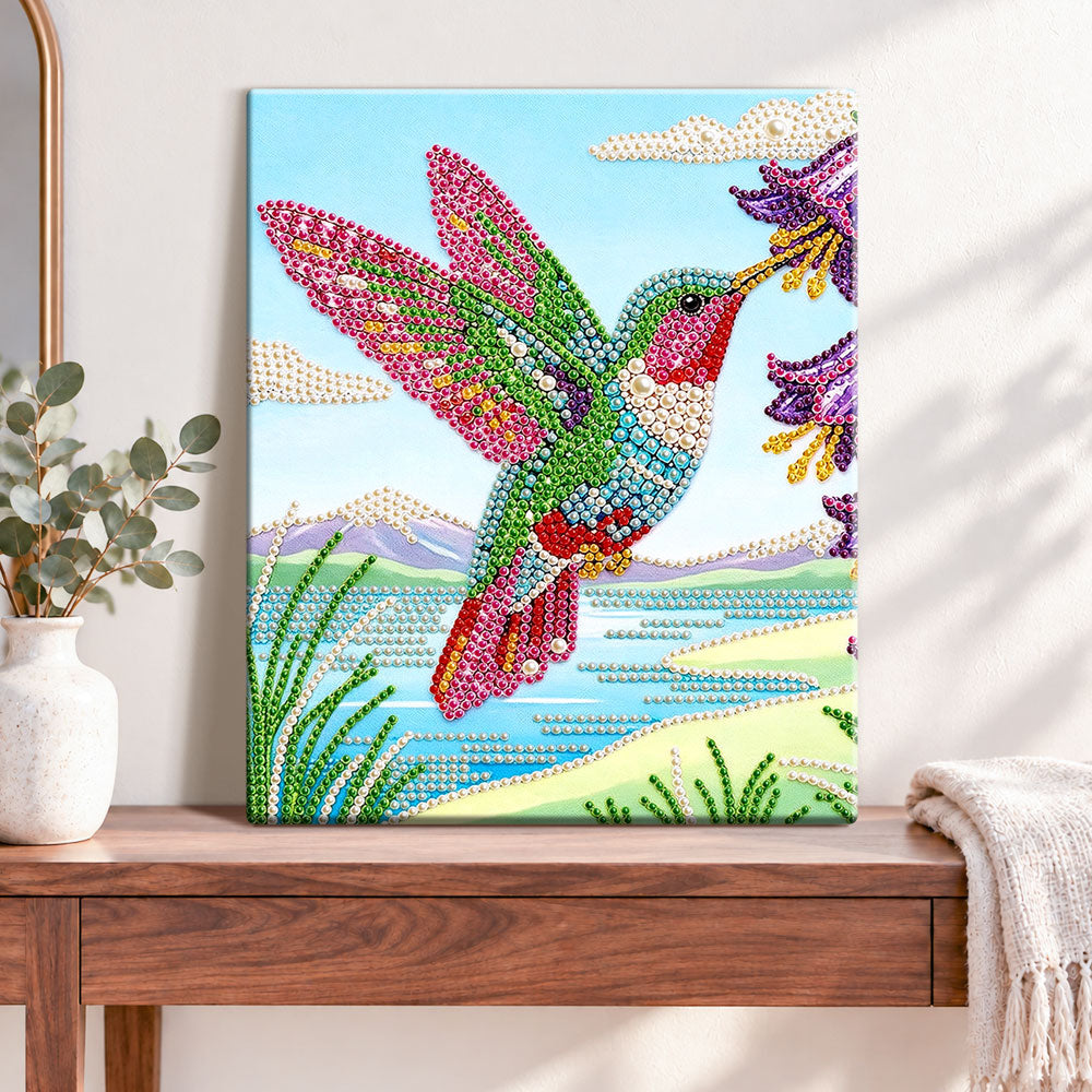 Finished hummingbird and wildflowers pearl diamond painting artwork displayed as home decor