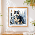 Finished husky in a snowy forest cross stitch artwork displayed