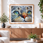 Finished hyper-realistic tabby cat portrait cross stitch artwork displayed