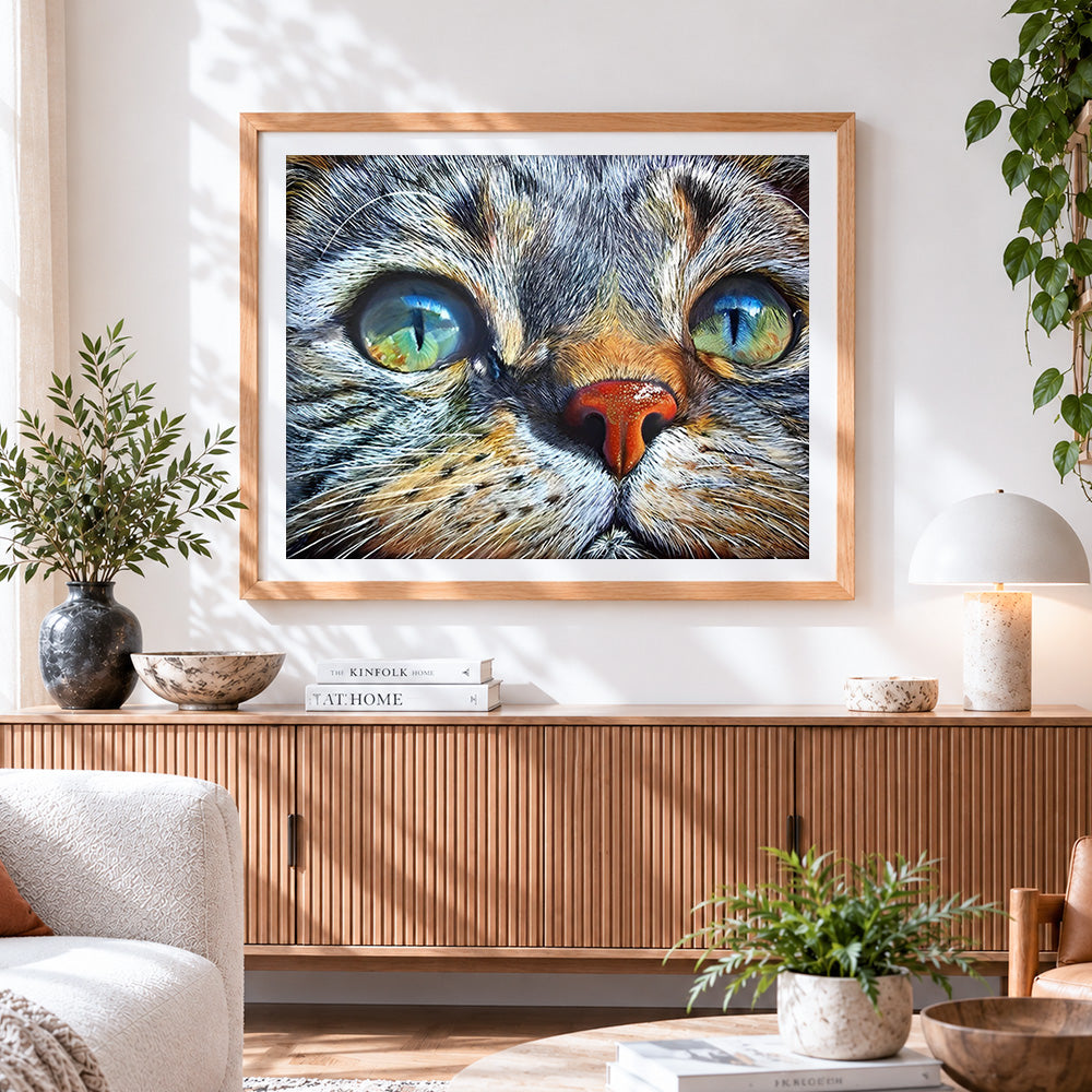 Finished hyper-realistic tabby cat portrait cross stitch artwork displayed