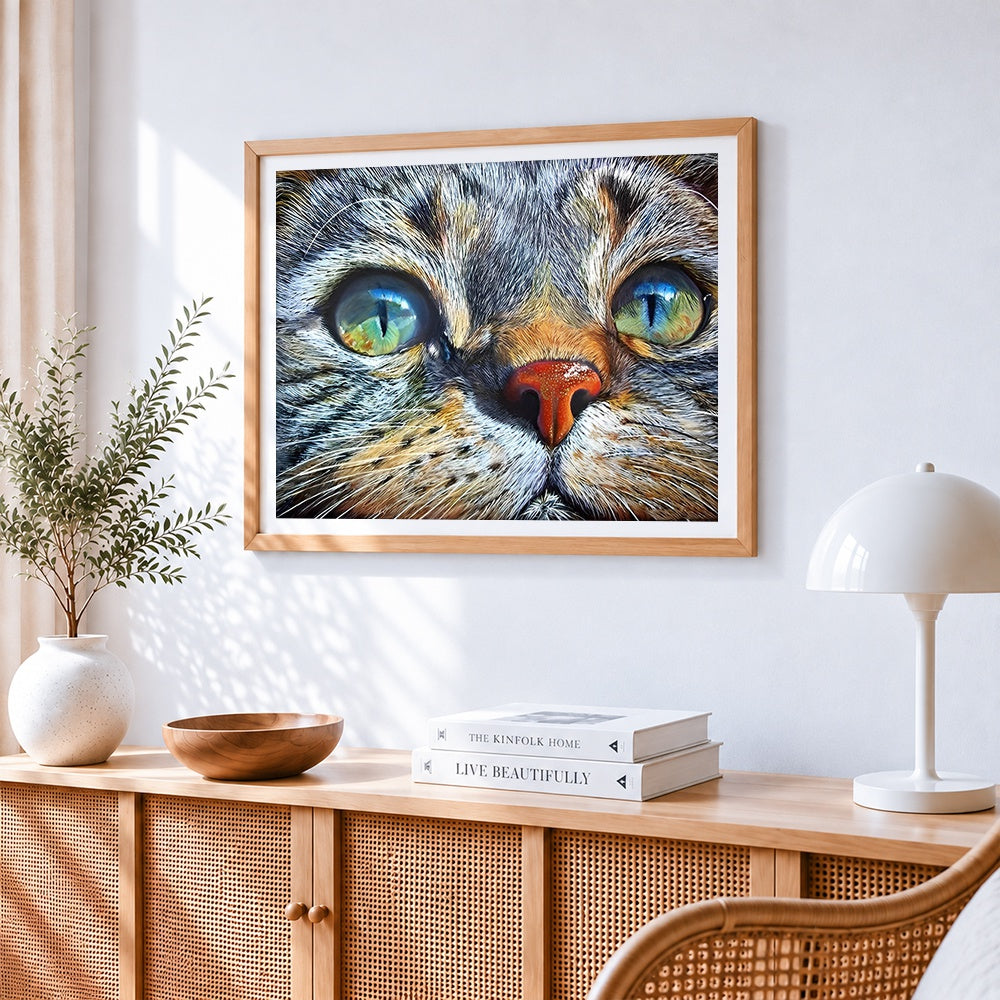 Hyper-realistic tabby cat portrait cross stitch artwork displayed on wall as home decor