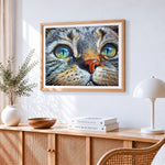 Hyper-realistic tabby cat portrait cross stitch artwork displayed on wall as home decor