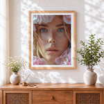 Finished hyperrealistic blue eyed woman cross stitch artwork displayed