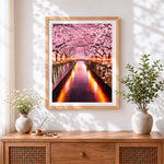 Finished illuminated cherry blossom tunnel cross stitch artwork displayed