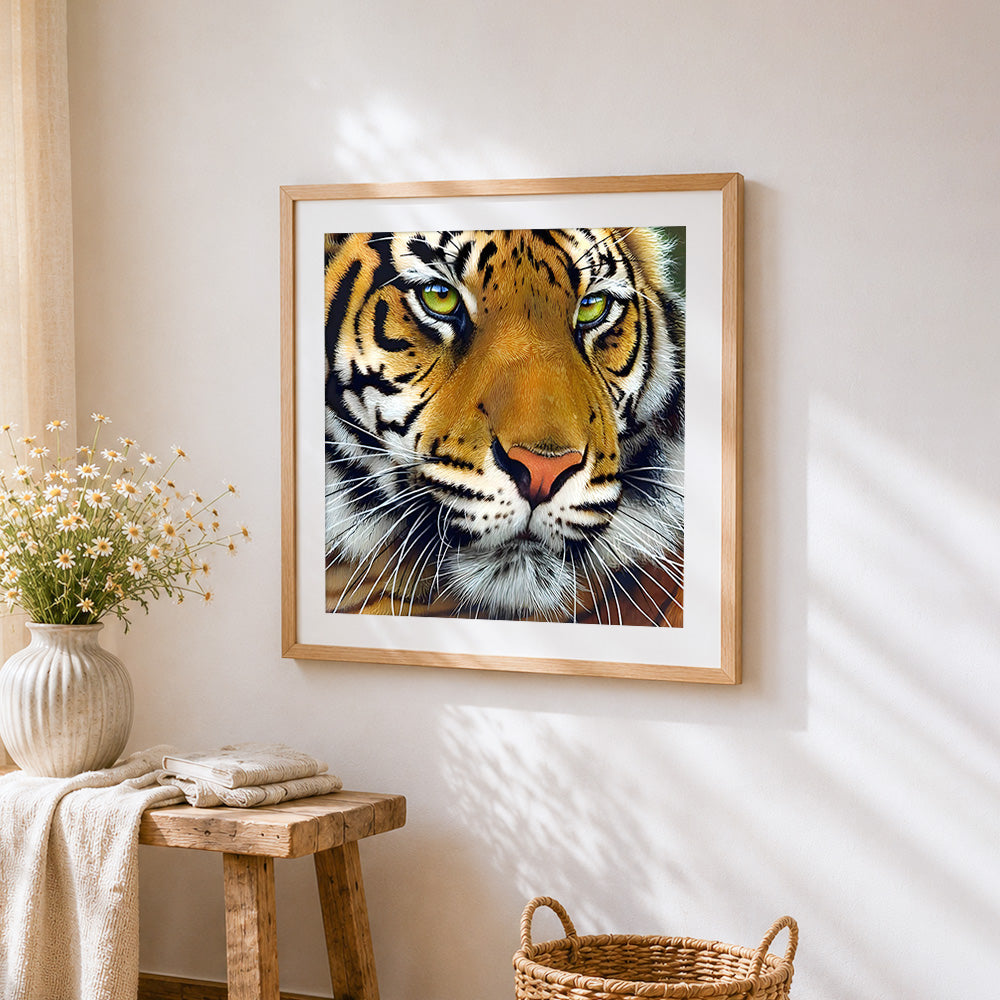 Intense bengal tiger face close-up cross stitch artwork displayed on wall as home decor