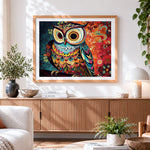Finished intricate colourful owl cross stitch artwork displayed